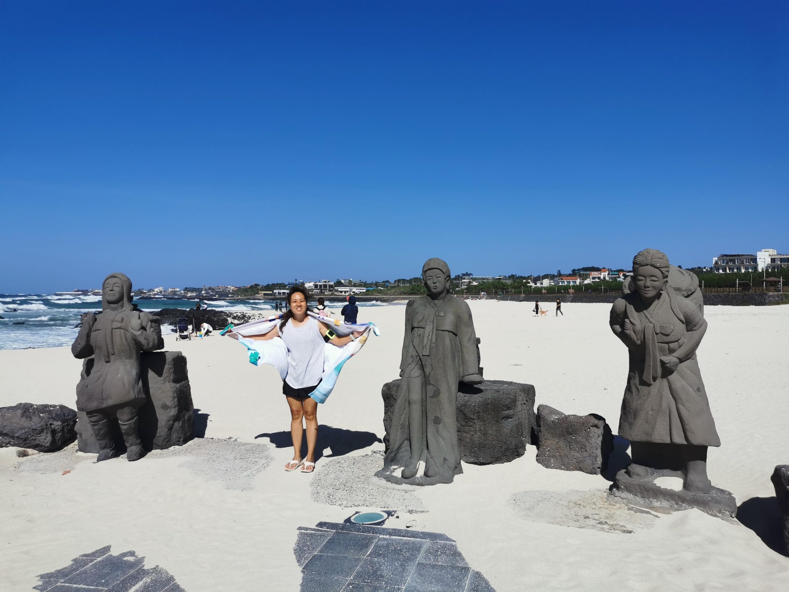 A picture at Gwakgi Beach in Jeju together with 3 haenyo statues.